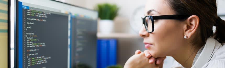 Woman working on computer with blue-violet light protective glasses