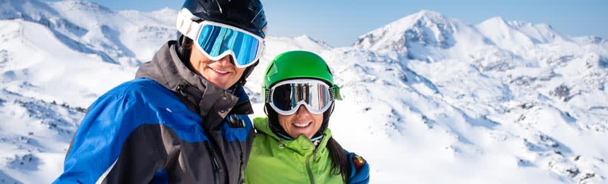 Man and woman wearing ski goggles