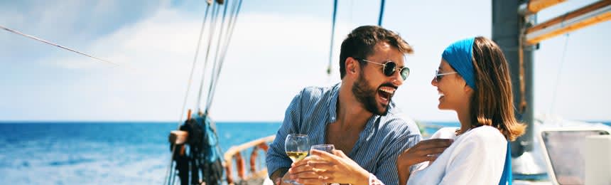 man and woman laughing on a sailboat