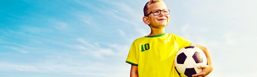 boy playing soccer with eyeglasses