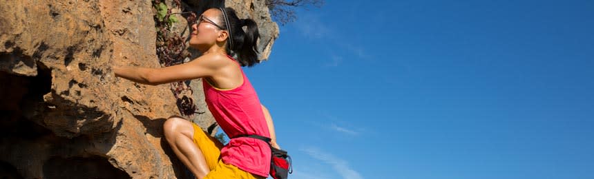 Woman wearing eyeglasses rock climbing