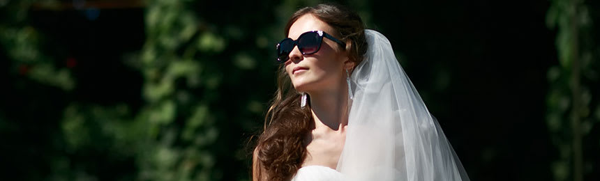 Bride with a veil wearing sunglasses